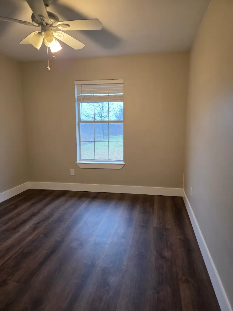 Beautifully restored bedroom with hardwood floors and fresh paint after water damage restoration