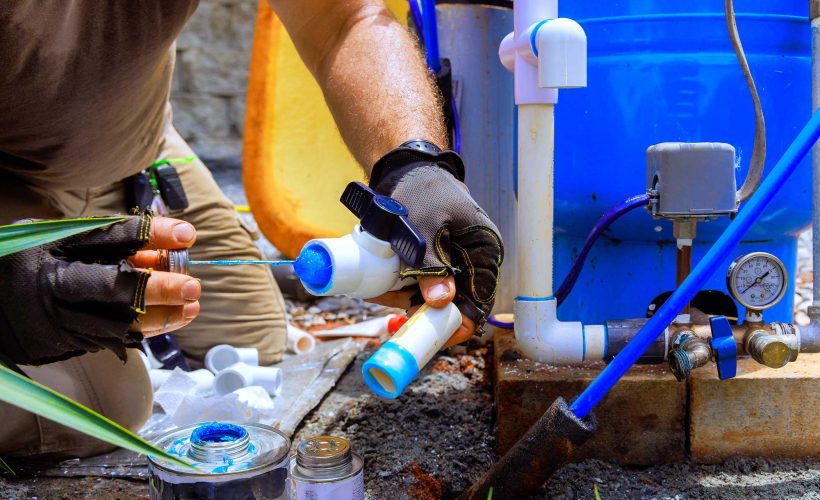 gluing pvc pipe plumber applies glue connected
